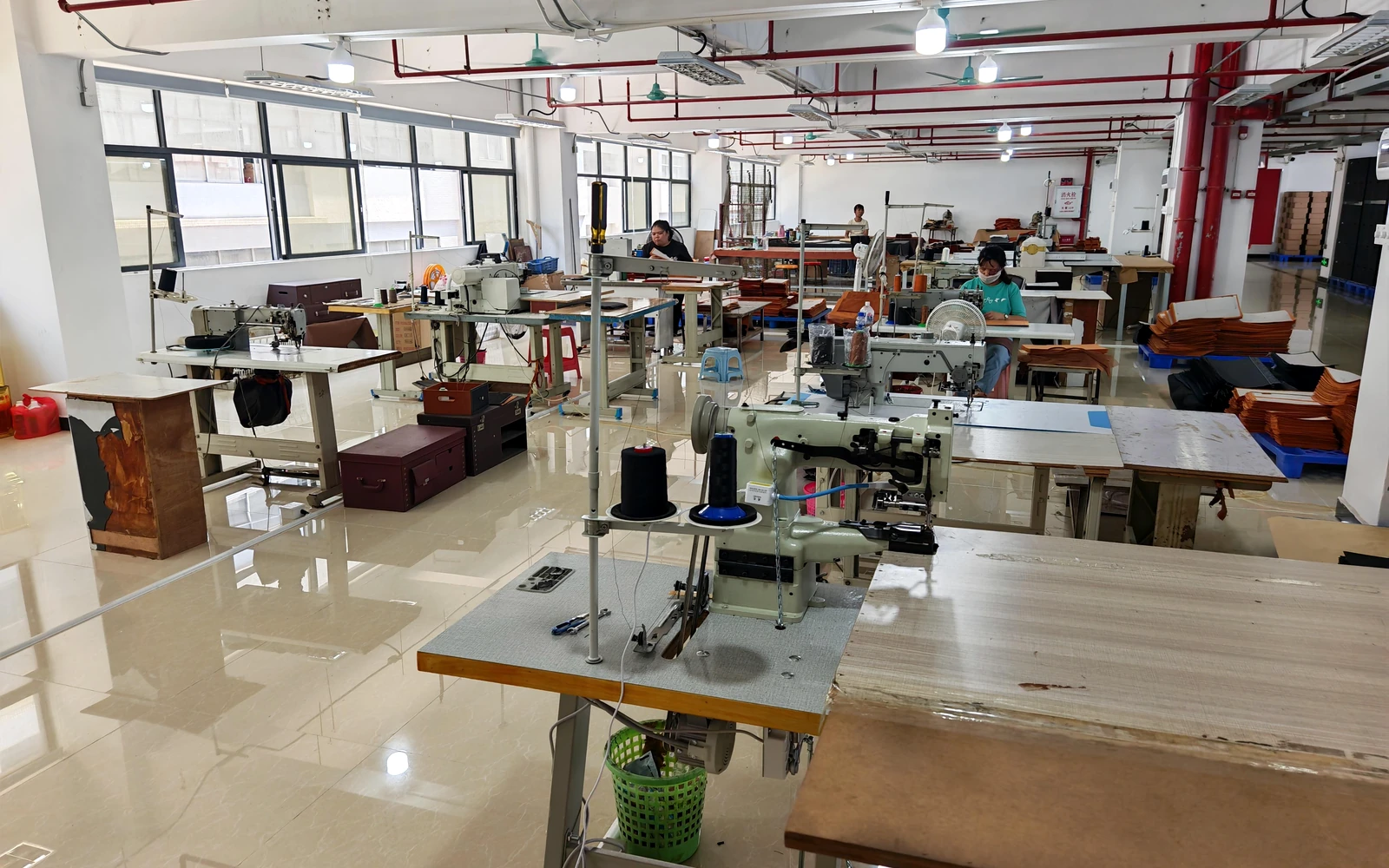 Sewing workshop with industrial sewing machines and active workstations